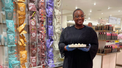 woman handing out sweet samples